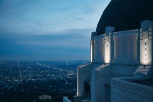 Griffith Observatory at dusk with a cityscape in the background